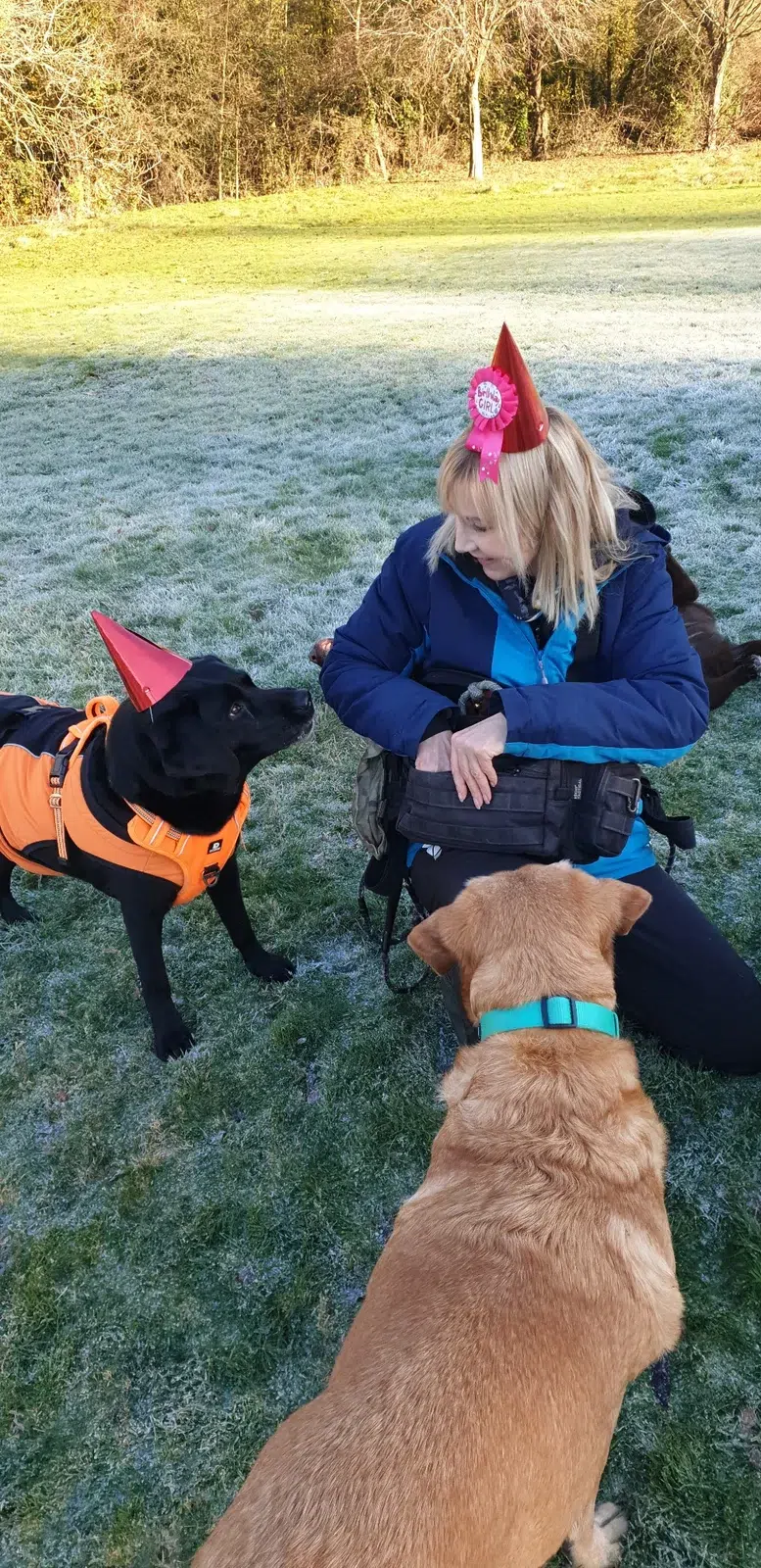 Michelle surrounded by dogs on a frosty walk