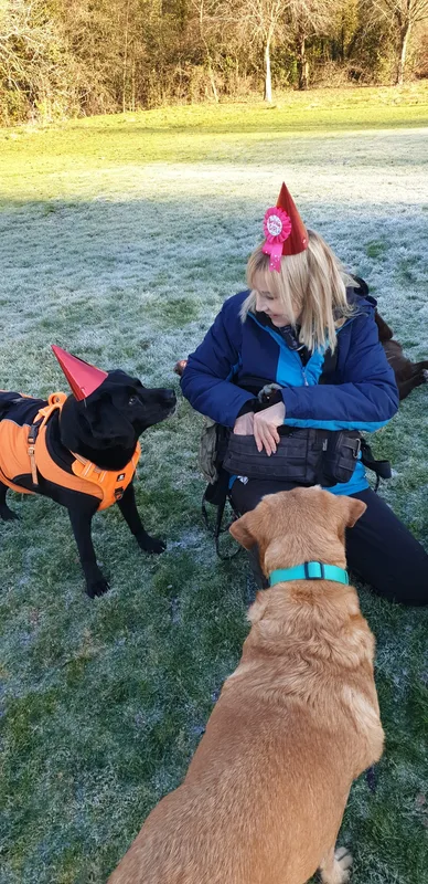 Michelle surrounded by dogs on a frosty walk